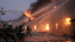 Ukrainian firefighters extinguish a blaze at a warehouse after a bombing in Kyiv, March 17, 2022.