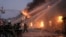 Ukrainian firefighters extinguish a blaze at a warehouse after a bombing in Kyiv, March 17, 2022. 