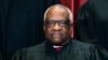 FILE - Justice Clarence Thomas sits during a group photo at the Supreme Court in Washington, April 23, 2021. 