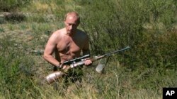 FILE -- In this Sept. 2010 file photo released Oct. 30, 2010, Russian President Vladimir Putin (then the prime minister) carries a hunting rifle in Russia's Siberian Tyva region.