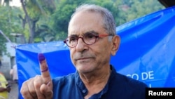East Timor president candidate Jose Ramos Horta shows his inked finger after casting his vote during the East Timorese presidential election at Dili, East Timor, March 19, 2022.