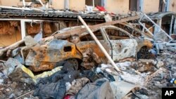 A car destroyed by shelling is seen in a street in Kharkiv, Ukraine, March 22, 2022.