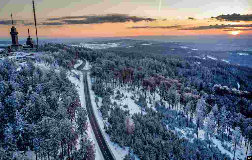 A road leads up to the top of the Feldberg mountain near Frankfurt, Germany, as the sun rises.