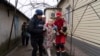 Associated Press photographer Evgeniy Maloletka helps a paramedic to transport a woman injured during shelling in Mariupol, eastern Ukraine, March 2, 2022.