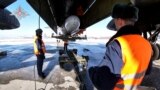 FILE - This handout video grab released by the Russian Defense Ministry on Feb. 19, 2022, shows Russian airmen examining a Tupolev Tu-95MS bomber aircraft, with an air-launched cruise missile at an undefined location in Russia.