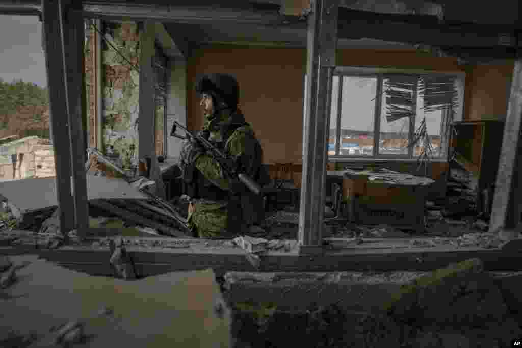 A Ukrainian serviceman stands in a heavily damaged building in Stoyanka.&nbsp;Ukrainian President Volodymyr Zelenskyy accused the West of lacking courage as his country fights to stave off Russia&#39;s invading troops, making an exasperated plea for fighter jets and tanks to sustain a defense in a conflict that has ground into a war of attrition.