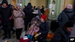 Ukrainian refugees wait at Przemysl train station, southeastern Poland, March 11, 2022.
