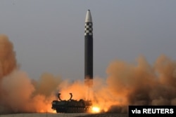 The test firing of what state media said was a North Korean "new type" of intercontinental ballistic missile is shown in this undated photo released March 24, 2022, by North Korea's Korean Central News Agency.