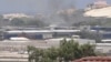 FILE - Smoke rises from behind buildings, in Mogadishu, Somalia, March 23, 2022, in this still image obtained from a social media video. (Twitter/@Hajishire/via Reuters)