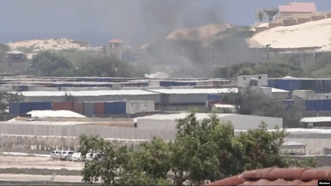 FILE - Smoke rises from behind buildings, in Mogadishu, Somalia, March 23, 2022, in this still image obtained from a social media video. (Twitter/@Hajishire/via Reuters)