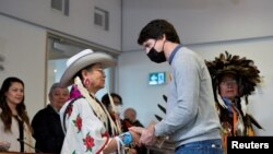 Canada's Prime Minister Justin Trudeau greets Joan Gentles of Chilcotin First Nation (Tsilhqot'in) at the Williams Lake First Nation, near a former residential school where a sweep indicated 93 possible unmarked graves, in Williams Lake, British Columbia, March 30, 2022.
