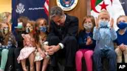 U.S. Secretary of State Antony Blinken listens to a question from the daughter of a U.S. Embassy staff member, March 30, 2022, while meeting with embassy staff and their families in Algiers, Algeria.