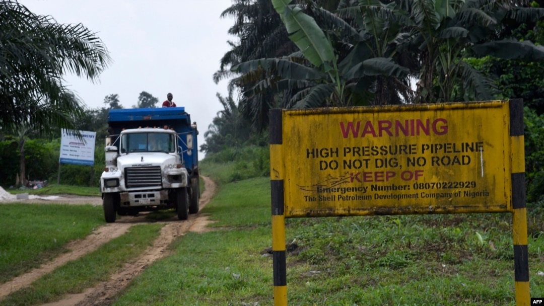FILE - A truck drives along a high pressure oil pipeline in Ejamah-Ebubu, Ogoniland, in Rivers State, southern Nigeria, Aug. 23, 2021. A pipeline owned by a Shell subsidiary spilled oil in the Niger Delta, officials said on Jan. 20, 2024.