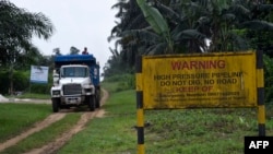 FILE - A truck drives along a high pressure oil pipeline in Ejamah-Ebubu, Ogoniland, in Rivers State, southern Nigeria, Aug. 23, 2021. A pipeline owned by a Shell subsidiary spilled oil in the Niger Delta, officials said on Jan. 20, 2024.