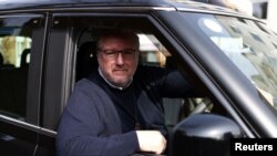 London black cab driver Matt Westfall, 52, poses for a photo during a Reuters interview in London, Britain, March 28, 2022.