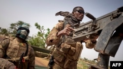 FILE - Soldiers of the Malian army are seen during a patrol on a road between Mopti and Djenne, in central Mali, Feb. 28, 2020.