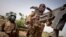 FILE - Soldiers of the Malian army are seen during a patrol on a road between Mopti and Djenne, in central Mali, Feb. 28, 2020.
