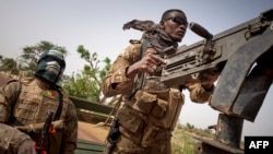 FILE - Soldiers of the Malian army are seen during a patrol on a road between Mopti and Djenne, in central Mali, Feb. 28, 2020.