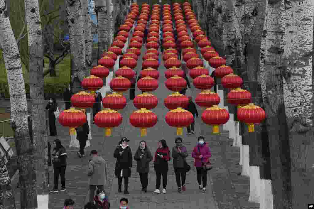 Visitors walk in a park in Beijing, China.