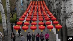 Visitors walk in a park in Beijing, China.