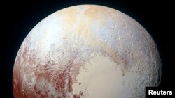 A heart shaped region named Sputnik Planum is seen in an enhanced view of Pluto in this undated image from NASA's New Horizons spacecraft, which flew past the dwarf planet in 2015. (REUTERS/NASA/JHUAPL/SwRI/Handout via Reuters)