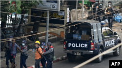 Police arrest people in Yangon, Myanmar, on February 27, 2021. At least five journalists remain in detention over their coverage of anti-coup protests. 