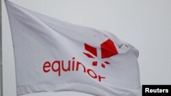 FILE - Equinor's flag flutters next to the company's headqurters in Stavanger, Norway, Dec. 5, 2019.