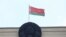 Başkent Minsk'te Bağımsız Meydanı'ndaki bir binasının tepesinde  asılı bir Belarus bayrağı