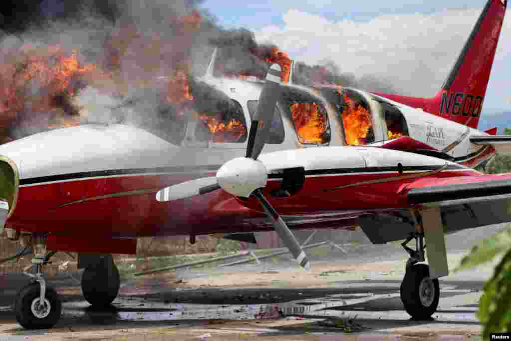 A plane belonging to U.S. missionary group Agape Flights is set on fire during protests demanding that the government of Prime Minister Ariel Henry do more to address gang violence, in Les Cayes, Haiti, March 29, 2022.