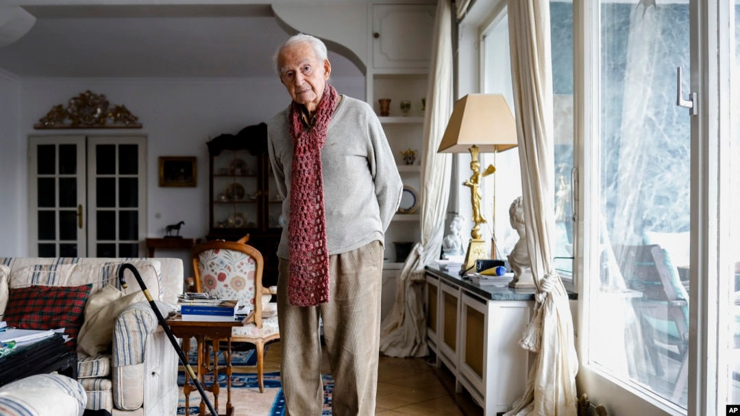 FILE - Leon Schwarzbaum poses for a photo in his home during an interview with the Associated Press in Berlin, Dec. 12, 2019.