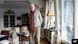 FILE - Leon Schwarzbaum poses for a photo in his home during an interview with the Associated Press in Berlin, Dec. 12, 2019.