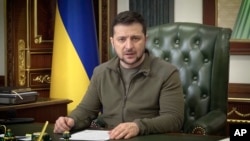 In this image from video provided by the Ukrainian Presidential Press Office and posted on Facebook, Ukrainian President Volodymyr Zelenskyy speaks in Kyiv, Ukraine, on early Wednesday, March 16, 2022. (Ukrainian Presidential Press Office via AP)