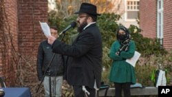 FILE - Photo provided by the University of Rhode Island. Rabbi Avraham Goldstein of the University of Rhode Island Chabad speaks at a peace vigil for Ukraine in Kingston, R.I., March 3, 2022.