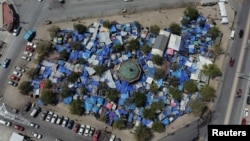 A makeshift migrant camp set up on a public square housing nearly 2,000 migrants is pictured near the Reynosa-Hidalgo International Bridge, in Reynosa, Mexico, March 31, 2022. 