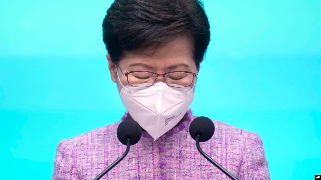 Hong Kong Chief Executive Carrie Lam pauses during a news conference in Hong Kong, Monday, April 4, 2022. (AP Photo/Vincent Yu, Pool)