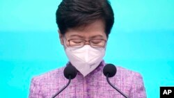 Hong Kong Chief Executive Carrie Lam pauses during a news conference in Hong Kong, Monday, April 4, 2022. (AP Photo/Vincent Yu, Pool)