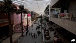 Shoppers stroll through The Avenues Mall in Kuwait City, Feb. 11, 2022. Kuwait is ranked each year as among the hottest places on the planet. Last summer, birds dropped dead from the sky and shellfish baked to death in the bay. (Maya Alleruzzo/AP)