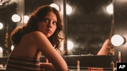 FILE - This image released by A24 shows Mia Goth in a scene from "X."