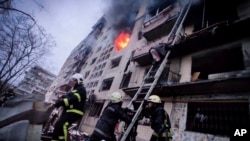 ​ក្រុម​ការងារ​ពន្លត់​អគ្គីភ័យ​កំពុង​តែ​ព្យាយាម​ពន្លត់អគ្គីភ័យ​នៅ​អគារ apartment​ មួយ ដែល​ត្រូវ​ភ្លើង​ឆេះ​ដោយសារ​ការ​វាយប្រហារ​ដោយ​គ្រាប់​ផ្លោង​របស់​រុស្ស៊ី ទីក្រុង​កៀវ ប្រទេស​អ៊ុយក្រែន ថ្ងៃទី១៤ ខែមីនា ឆ្នាំ២០២២។ (Ukrainian State Emergency Service via AP)