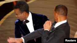 Aktor Will Smith (kanan) menampar komedian Chris Rock setelah sang komedian melontarkan lelucon tentang istri Smith dalam ajang penghargaan Oscar ke-94 yang digelar di Los Angeles, California, pada 27 Maret 2022. 