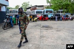 A soldier guards a fuel station in Colombo, Sri Lanka, March 22, 2022.