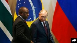 FILE - South Africa's President Cyril Ramaphosa, left, and Russia's President Vladimir Putin arrive for the Leaders Dialogue with BRICS Business Council and the New Development Bank, at the Itamaraty Palace in Brasilia, Brazil, Nov. 14, 2019.