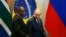 FILE - South Africa's President Cyril Ramaphosa, left, and Russia's President Vladimir Putin arrive for the Leaders Dialogue with BRICS Business Council and the New Development Bank, at the Itamaraty Palace in Brasilia, Brazil, Nov. 14, 2019.