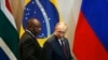 FILE - South Africa's President Cyril Ramaphosa, left, and Russia's President Vladimir Putin arrive for the Leaders Dialogue with BRICS Business Council and the New Development Bank, at the Itamaraty Palace in Brasilia, Brazil, Nov. 14, 2019.