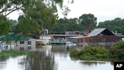 FILE - Buildings are surrounded by flood waters in Londonderry on the outskirts of Sydney, Australia, March 3, 2022.