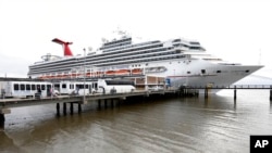 FILE - Passengers disembark from the Carnival Sunshine cruise ship March 16, 2020, in Charleston, SC.