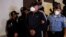 Agentes policiales escoltan al exjefe policial Juan Carlos "El Tigre" Bonilla, buscado por EE.UU. por narcotráfico, para presentarlo ante los medios de comunicación en una base policial tras su detención tras varios meses prófugo, en Tegucigalpa. Honduras 9 de marzo de 2022.