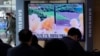  FILE - People watch a TV showing a file image of North Korea's missile launch during a news program at the Seoul Railway Station in Seoul, South Korea, March 5, 2022. 