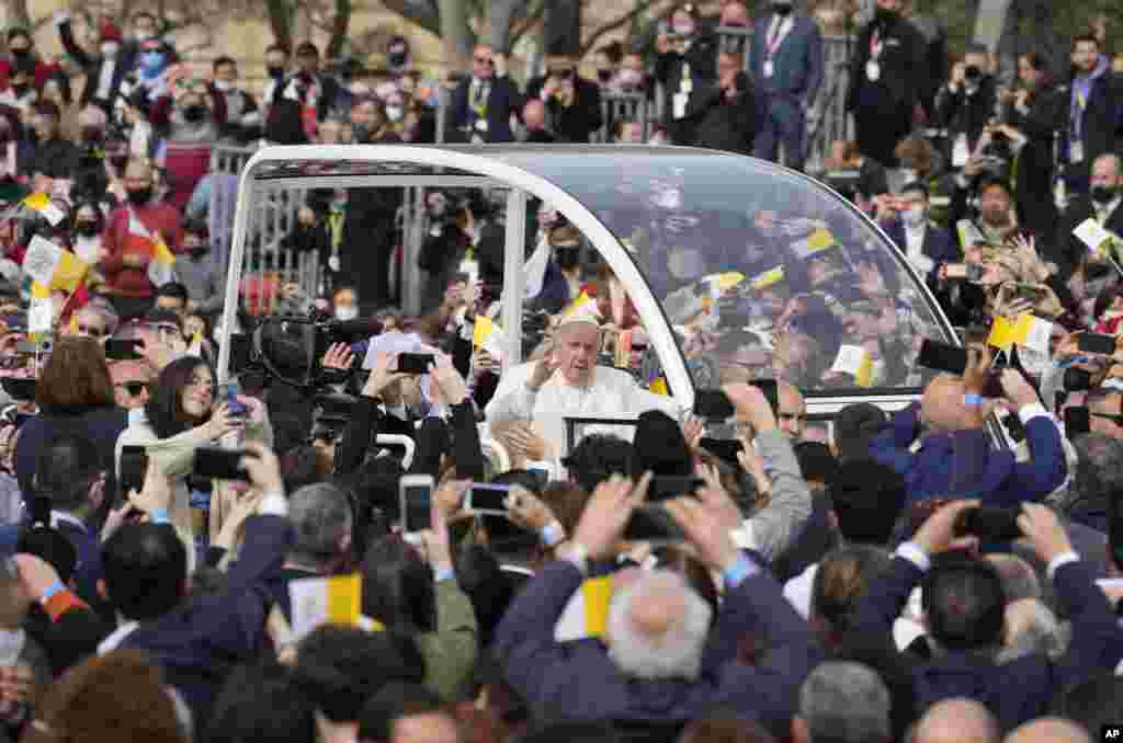 Pope Francis arrives in his popemobile at the Granaries Square in Floriana, Malta, to celebrate a Mass.