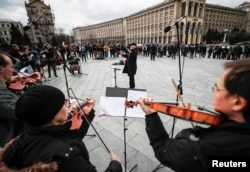 Musicians of the Kyiv-Classic Symphony Orchestra under the direction of conductor Herman Makarenko perform, during an open-air concert named "Free Sky" at the Independence Square in central Kyiv, Ukraine, March 9, 2022.